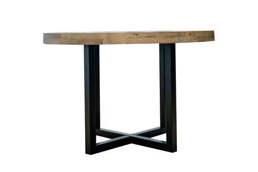 The New Jersey Dining Table features a thick, natural wood round top and a black metal crossed-leg base, creating an industrial look. It is shown against a plain white background.