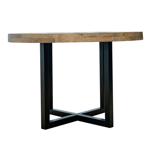 The New Jersey Dining Table features a thick, natural wood round top and a black metal crossed-leg base, creating an industrial look. It is shown against a plain white background.