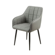 The Bianco dining chair is a modern gray bucket seat with quilted upholstery, black metal legs, and curved armrests for a stylish look.