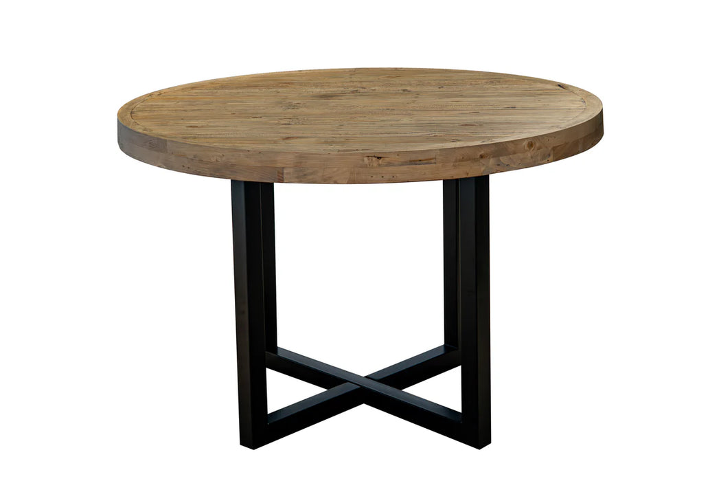 The New Jersey Dining Table features a round, thick reclaimed pine top and a black metal crossed-leg base, shown against a plain white background.