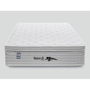 The Balmoral Mattress, featuring a white quilted design with the HoneyB logo and a side graphic, is crafted from quality fabrics and displayed against a plain gray background.