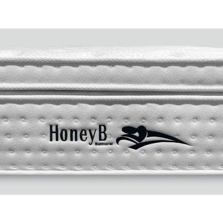 Close-up of a white Balmoral Mattress featuring the HoneyB brand and a black reclining figure logo on the side panel, crafted from quality fabrics for superior comfort.