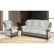 Classic style white and beige quilted sofa and matching armchair on a light shag rug.