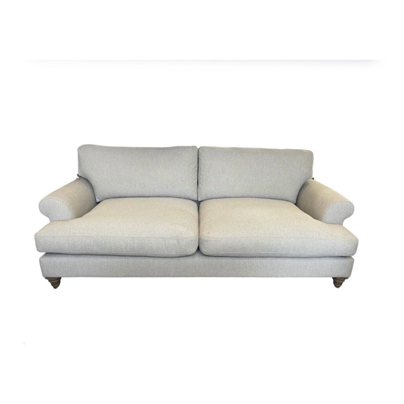 A light gray Monroe Sofa with two seat and back cushions, rounded armrests, upholstered in Irish aqua clean fabric, shown with wooden legs against a white background.