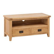A rectangular oak TV unit with two drawers, bronze handles, and a shelf, set against a white background.