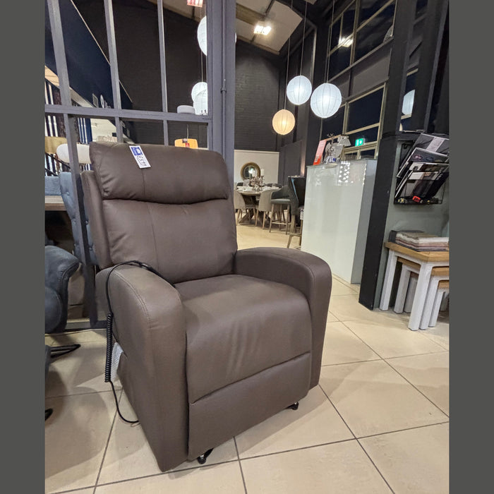 A brown lift and rise chair with twin motors, displayed in a furniture store setting.