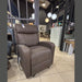 A brown lift and rise chair with twin motors, displayed in a furniture store setting.