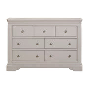 The Lima Wide Chest is a light gray wooden dresser with seven drawers and silver knobs. Part of our Taupe Bedroom Range, it features a classic, sturdy design and smooth finish—ideal to pair with bedside tables.