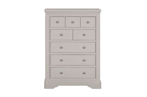 The Lima Tall Chest, in light gray with a modern design, features seven drawers of varying sizes, each with a round silver knob—an ideal addition to any taupe bedroom collection.