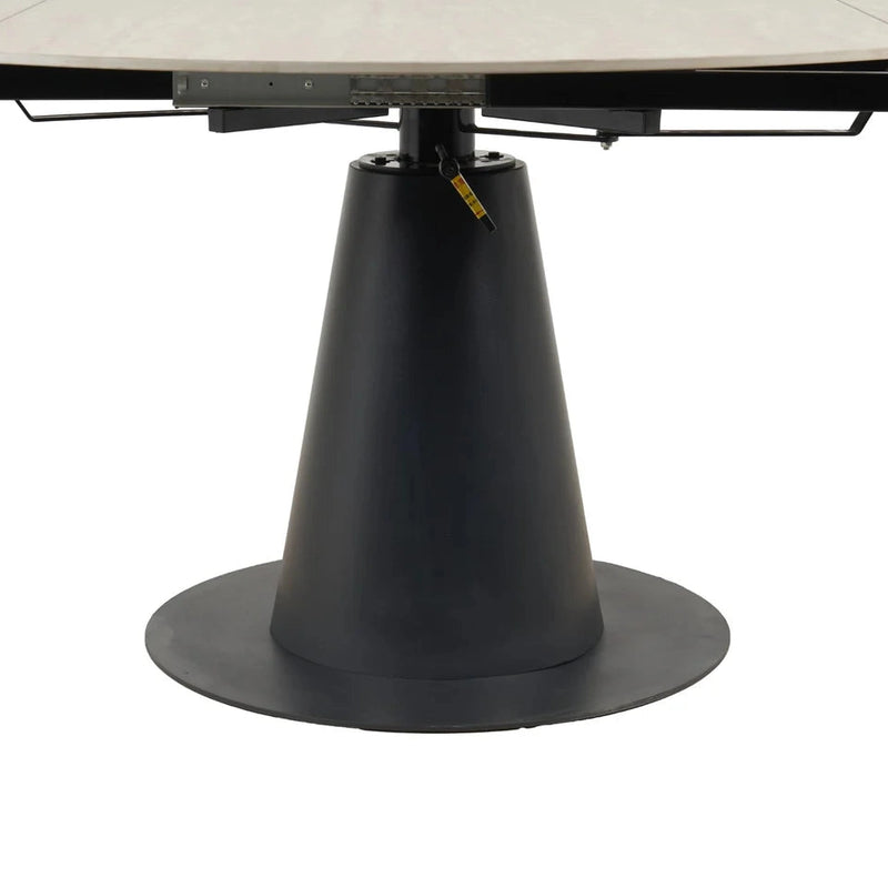 A close-up of the Como Swivel Dining Table's round, black, cone-shaped pedestal base with visible metal mechanisms beneath its modern tabletop.