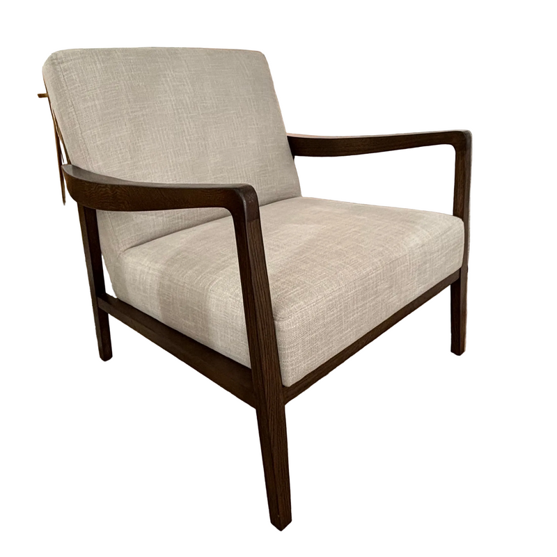 The Monza Armchair features light beige linen upholstery and a dark walnut frame with straight arms and legs, shown isolated on a white background.