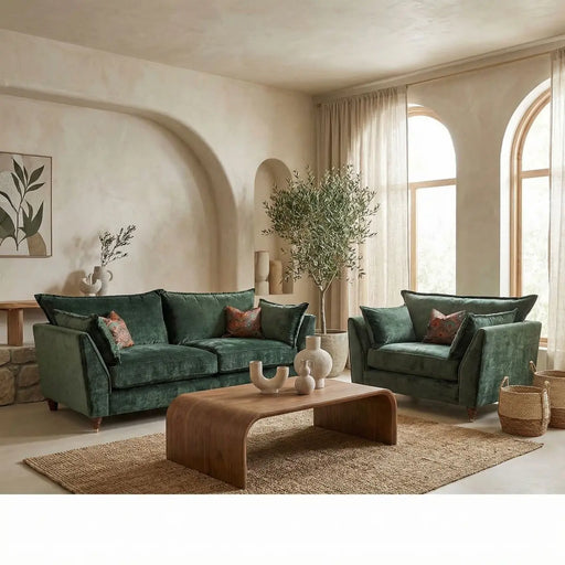 An elegant living room featuring a Cleo Range sofa, wooden coffee table, woven rug, sheer curtains on arched windows, a potted tree, and minimalistic wall art.
