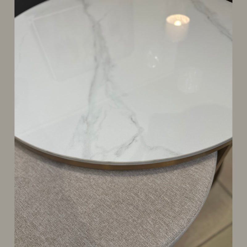 A close-up of two overlapping round Vienna Coffee Table + Footstool pieces: the coffee table features a glossy white marble top with gray veining, while the footstool below has a light gray textured fabric surface.