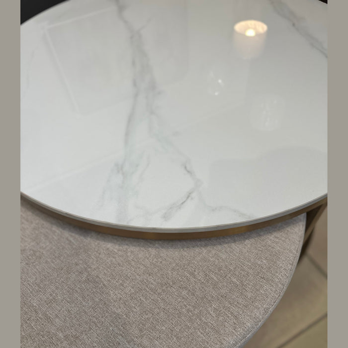A close-up of two overlapping round Vienna Coffee Table + Footstool pieces: the coffee table features a glossy white marble top with gray veining, while the footstool below has a light gray textured fabric surface.