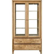 The Solstice Display Cabinet features a chevron pattern, glass doors, three interior shelves, and two carved drawers at the bottom, shown against a white background.