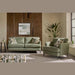 A modern living room featuring the Joni Range sofa and matching armchair, patterned cushions, a potted plant, side table, pouf, and wooden accent wall with abstract art. Sunlight streams in—perfect for contemporary homes.