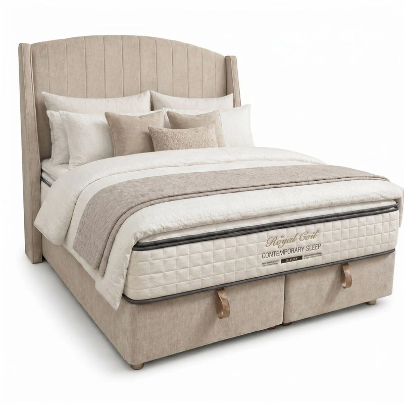 The Westbury Storage Bedframe is a plush beige lift-up bed with a tall, curved winged headboard, dressed in white and beige bedding, multiple pillows, and a patterned mattress labeled Regal Earl Contemporary Sleep.
