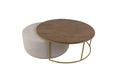 The Todi Round Coffee Table & Stool Set features a round wooden tabletop on a gold metal frame with a matching light beige upholstered ottoman, both with gold bases, ideal for modern interiors and styled against a white background.