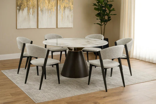 A modern dining room showcases the Fusion 150cm Round Table with 6 Fusion Chairs in light gray, complemented by a large plant, beige walls, abstract art, sheer curtains, and wood flooring.