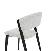 The Fusion 150cm Round Table + 6 Titan Chairs set features modern dining chairs with light gray upholstery and angled black legs, perfectly complementing the round table—ideal for stylish dining spaces, as shown against a white background.