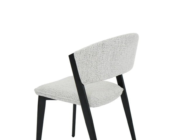 The Fusion 150cm Round Table + 6 Fusion Chairs set includes modern dining chairs with light gray upholstery and black angled legs, showcasing a minimalist style and ideal for a sleek dining area, shown against a plain white background.