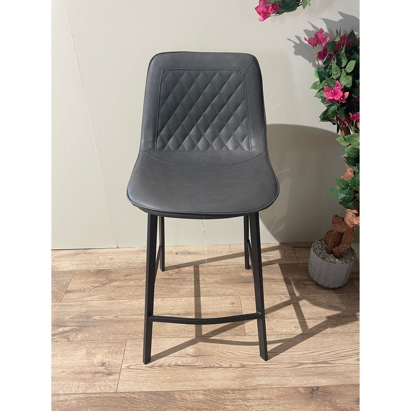 Contemporary dark gray faux leather bar stool with a diamond-quilted backrest and slim black metal legs.