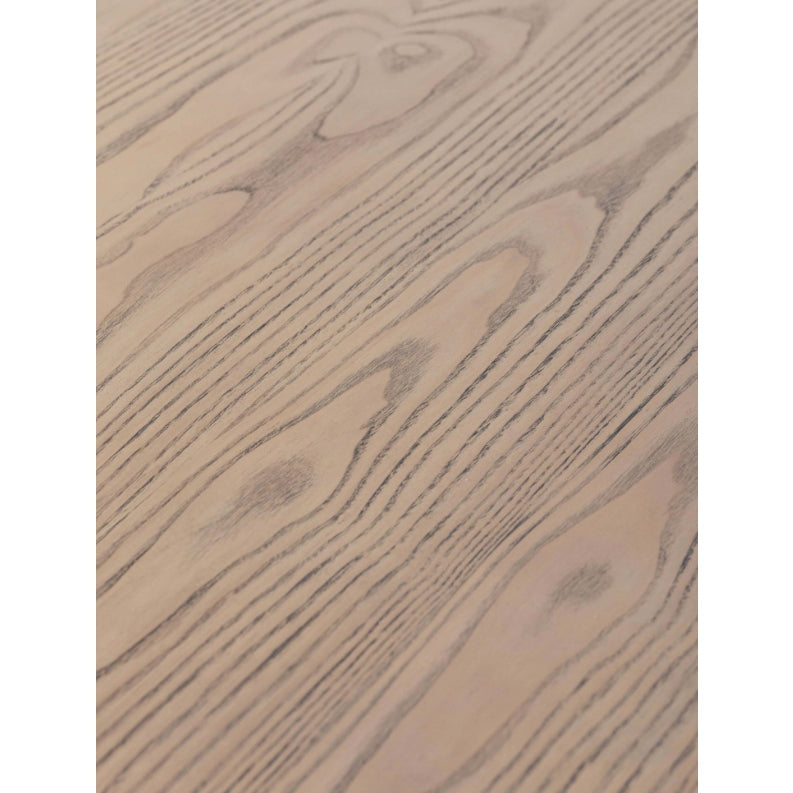 Close-up of the Falun Round Dining Table's light wood surface, showcasing prominent natural grain patterns and knots. The smooth, matte finish emphasizes its elegant craftsmanship.