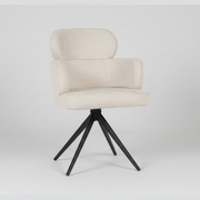 The Orbit Dining Chair features natural beige fabric upholstery, a curved backrest with armrests, and four black metal legs that splay outward for support. Shown against a plain white background.