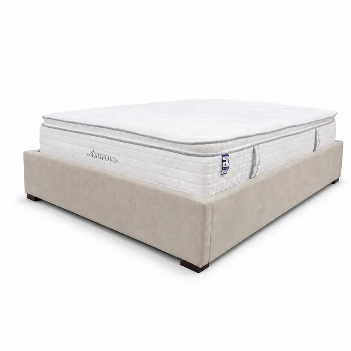 A beige upholstered bed frame holds a thick, white Ashford Pillowtop Mattress with cooling gel memory foam and a quilted surface, set against a plain white background.