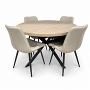 The Dalton Table + 4 Lyra Chairs set features a round dining table with four beige, padded chairs with black metal legs, all arranged on a white background for a subtle industrial look.