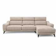 The Nomi Sliding Seat Chaise is a modern beige sofa with three seat cushions, plush backrests, a right-facing chaise lounge, and black legs, showcased against a white background.