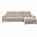 The Nomi Sliding Seat Chaise is a modern beige sofa with three seat cushions, plush backrests, a right-facing chaise lounge, and black legs, showcased against a white background.