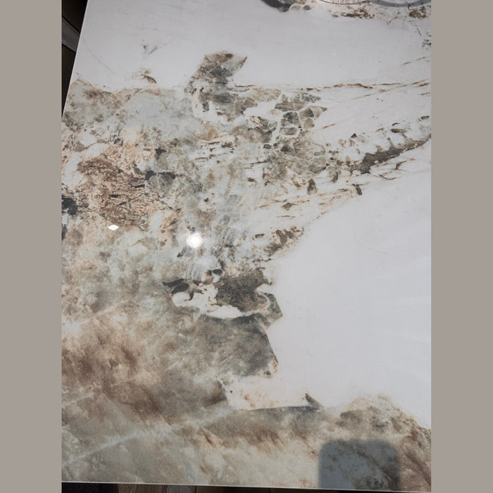 The Sorrento Dining Table features a marble effect with brown, beige, and gray veining on a white background, creating an abstract natural stone look.