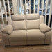 The Lorenzo Electric Recliner Sofa, featuring plush washable cushions and wide armrests, is showcased on a wooden floor in a bright living room with decorative accents and additional furniture in the background.