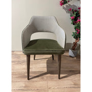 Contemporary armchair with dark tapered wood legs and a cutout back, upholstered in a stylish two-tone green and gray fabric.