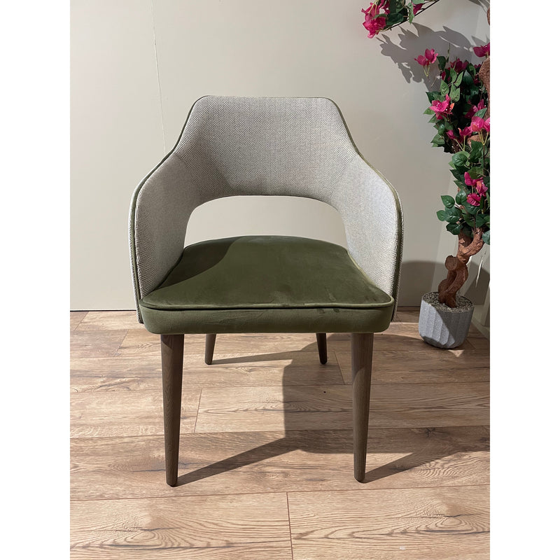 Contemporary armchair with dark tapered wood legs and a cutout back, upholstered in a stylish two-tone green and gray fabric.