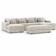 The Henley Sofa is a beige sectional with a left-facing chaise, matching ottoman, and five back cushions. It comes with four decorative pillows featuring chevron patterns. This contemporary sofa showcases low wooden legs and a plush, modern design, all upholstered in soft chenille fabric for enhanced comfort and style.