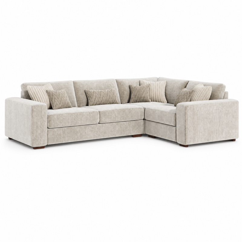 The Henley Sofa is an L-shaped sectional upholstered in light beige chenille fabric, featuring six seat cushions, seven matching throw pillows, and short wooden legs. Set against a plain white background, this contemporary piece seamlessly blends comfort and style for any modern living space.