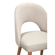 The Florence Counter Stool features a curved, upholstered backrest in light beige fabric, a padded cream-colored seat, and wooden legs, shown against a white background.