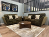 Two comfortable Cosmos Sofas with beige accent pillows face each other in a modern living room, divided by a round wooden coffee table on a light rug. Two abstract artworks hang above one sofa on the light blue wall.