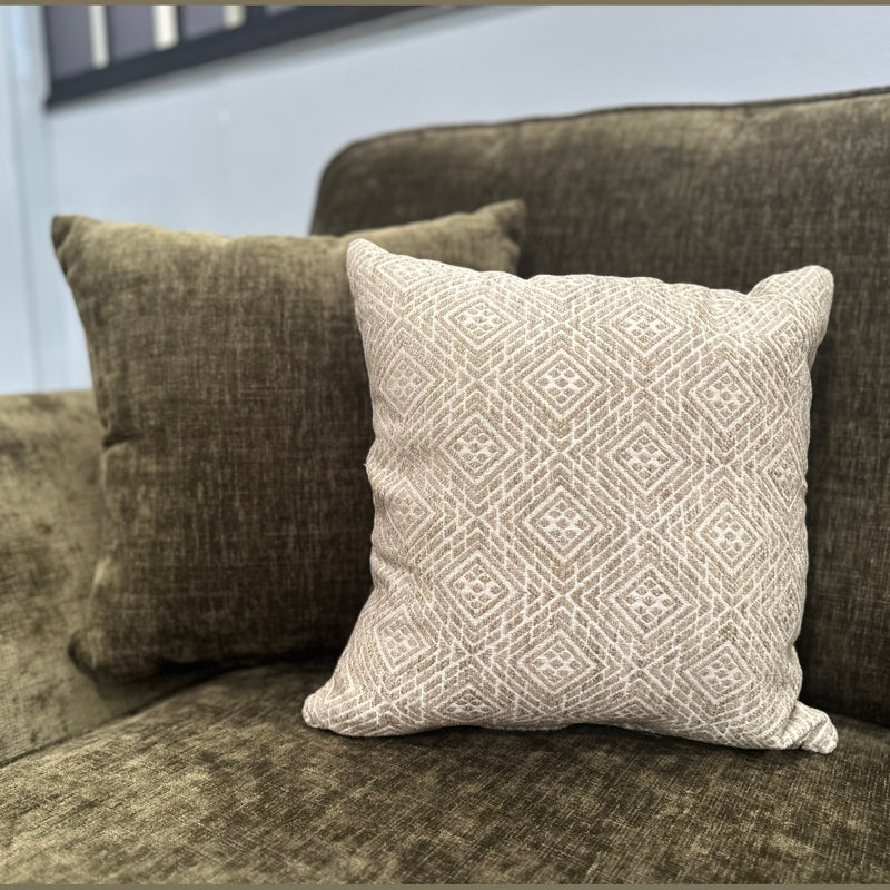 A dark green Cosmos Sofa featuring two cushions—one solid dark green and one light beige with a geometric pattern—placed side by side against the backrest for a comfortable, stylish look.