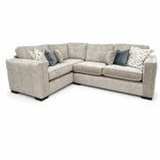 The Ivy Corner Sofa features a light gray L-shaped design, contemporary silhouette, plush cushions, dark wood legs, and decorative throw pillows in blue, white, and gray.