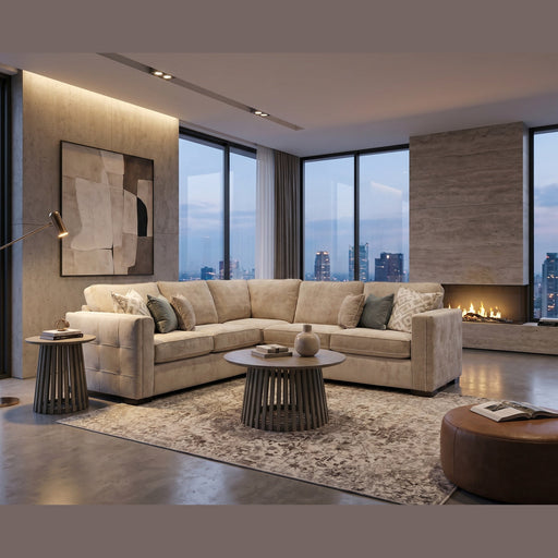 A modern living room features the Ivy Corner Sofa in beige with a contemporary silhouette, a round coffee table, side tables, abstract wall art, floor lamp, fireplace, and floor-to-ceiling windows overlooking a city skyline at dusk.