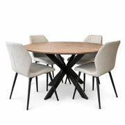 The Elson Round Table, featuring black X legs, is paired with four Lyra Chairs in beige upholstery and black metal legs, all arranged neatly for a modern style look.