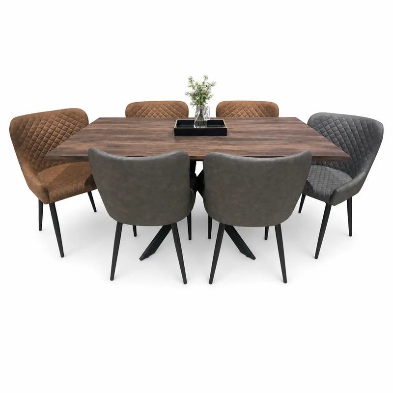 The Elson Table & 6 Diamond Chairs - Special Offer features a wooden dining table surrounded by six cushioned chairs—three brown and three gray. On the table, you'll find a small vase with flowers and a rectangular black tray.