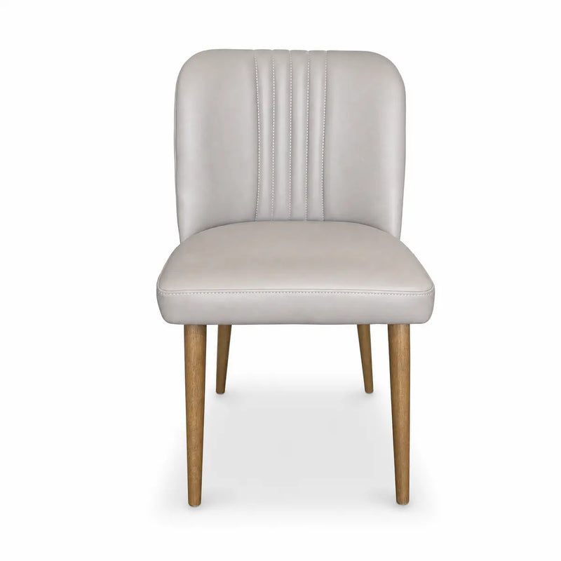 Front view of the Mia Dining Chair featuring a light grey upholstered seat and backrest with vertical stitching details, supported by four solid oak legs.