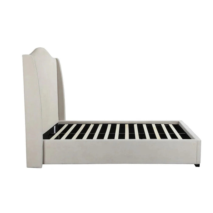 Side view of the Venice Bedframe, featuring a cream upholstered design with a tall, curved headboard and wooden slats for mattress support, exemplifying modern luxury against a plain white background.