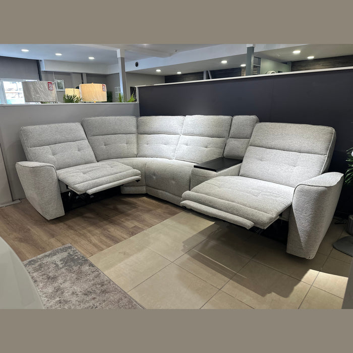 The Avery Electric Recliner Corner is a modern light gray L-shaped sectional sofa featuring two recliner seats, perfect as a contemporary living room centerpiece, shown here in a showroom with wooden and tile flooring.
