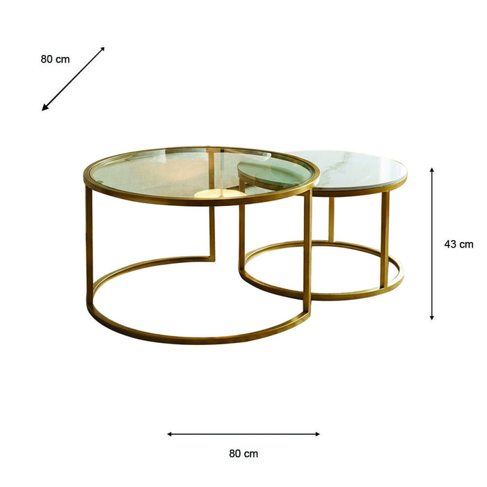 Introducing the Salzburg Nest: a set of two round coffee tables showcasing a refined nesting design with gleaming gold metal frames and sleek glass tops. The larger table measures 80 cm in diameter and 43 cm in height, while the smaller table tucks partially beneath for an elegant, space-saving arrangement. Ideal for modern interiors, Salzburg Nest effortlessly blends practicality with chic style inspired by marble and glass trends.