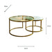 Introducing the Salzburg Nest: a set of two round coffee tables showcasing a refined nesting design with gleaming gold metal frames and sleek glass tops. The larger table measures 80 cm in diameter and 43 cm in height, while the smaller table tucks partially beneath for an elegant, space-saving arrangement. Ideal for modern interiors, Salzburg Nest effortlessly blends practicality with chic style inspired by marble and glass trends.